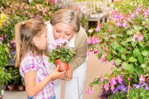 Garden center girl with grandmother smell flower